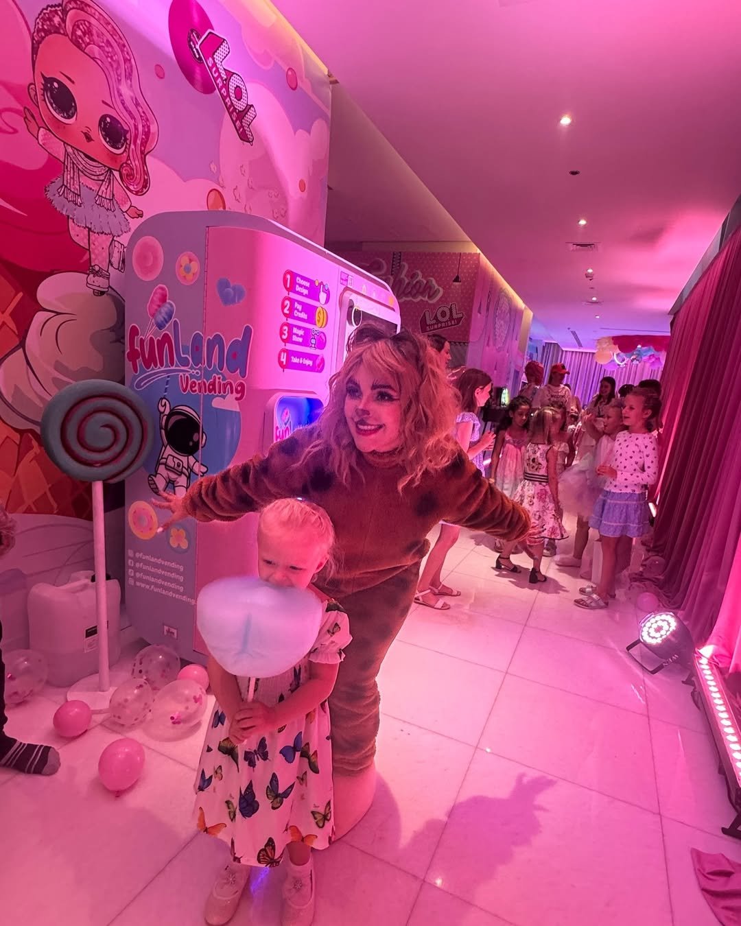 Kids gathered around a Funland Vending cotton candy machine at a Dubai birthday party