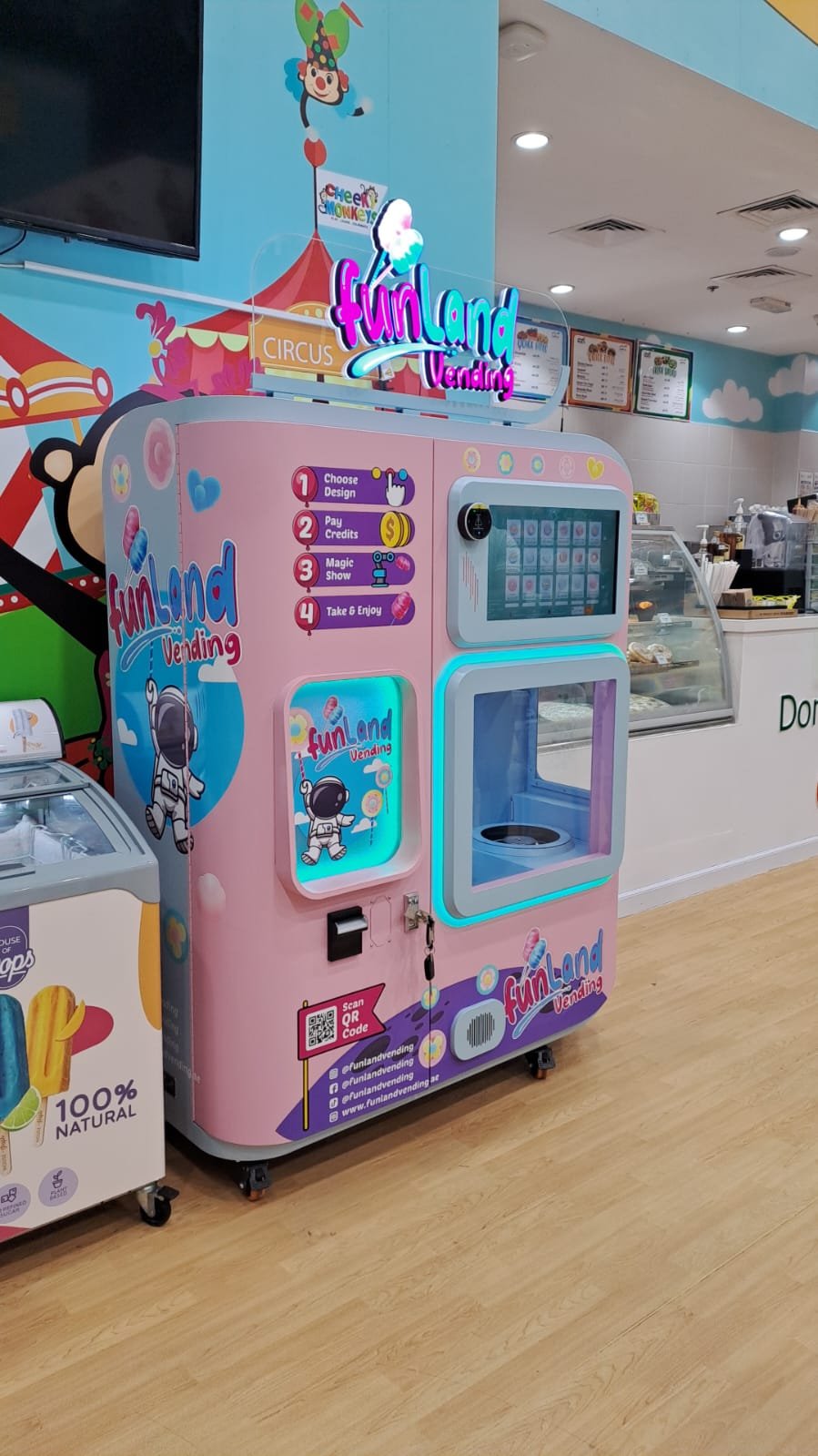 Close-up of the robotic spinner head and arm inside a Funland Vending machine