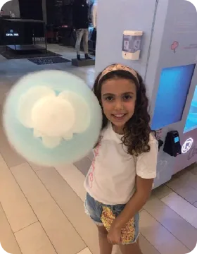 Children laughing with fresh cotton candy cones from Funland Vending at a Dubai venue